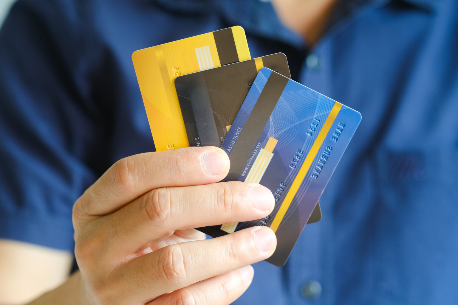 Person holding multiple credit cards